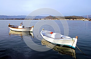 Two fishing boats in the harbor at Nafplio in Greece