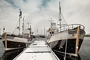 Two fishing boats near the pier. Tonned image