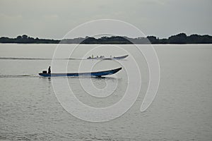 Two fishing boats sail along the Malecon 2000 embankment in Guayaquil