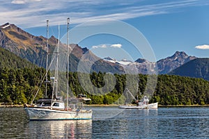 Two fishing boats sailing in harbor in Alaska