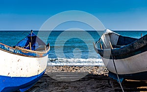 Two fishing boats resting on the beach