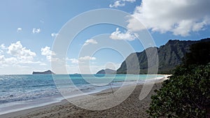 Two Fishing Poles in the sand as Gentle wave lap on Waimanalo Beach