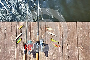 Two fishing rods with reels and artificial spinning lures.