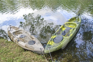 Two fishing single seat kayak on the river