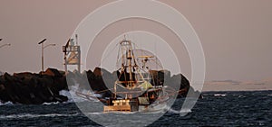 Two fishing trawlers heading out to sea