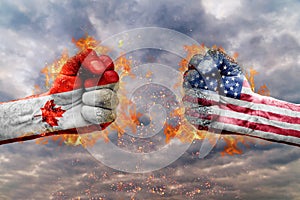 Two fist with the flag of Canada and USA faced at each other