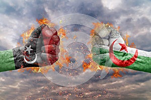 Two fist with the flag of Libya and Alegria faced at each other photo