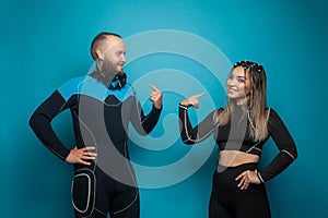 Two fit people on blue background. Happy man and woman portrait