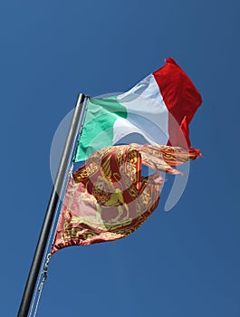 Two flag on the wind one italian and one of Veneto Region in Nor photo