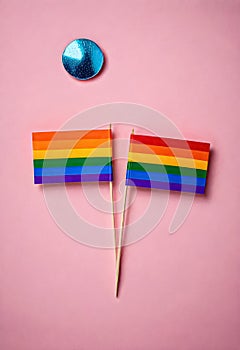 two flags with rainbow colors on them are on a pink background