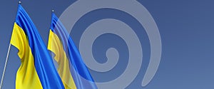 Two flags of Ukraine on flagpoles on side. Flags on a blue background. Place for text. Independent Ukraine. Ukrainian state symbol
