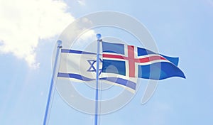 Two flags waving against blue sky