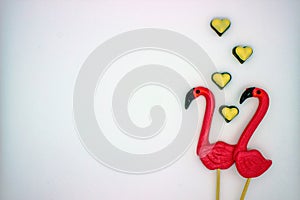 Two flamingo-shaped lollipop candies