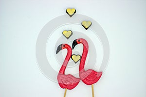 Two flamingo-shaped lollipop candies