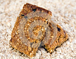 Two flapjacks stacked on an oat background