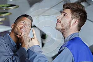 two flight engineers under airplane