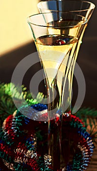 Two flutes of Champagne, Christmas wreath and spruce branch