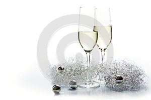 Two flutes champagne glasses for new year and silver decoration