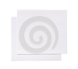 Two folded pieces of white tissue paper or napkin in stack tidily prepared for use in toilet or restroom isolated on white photo
