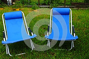 Two folding deck chairs on the grass