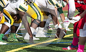 Two football teams lined up for the snap of the football