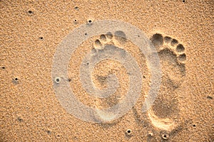 Two footprints on the sand beach