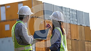 Two foreman checking and control loading containers box from cargo