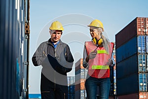 Two foreman man & woman worker working checking at Container cargo harbor to loading containers. Dock male and female staff