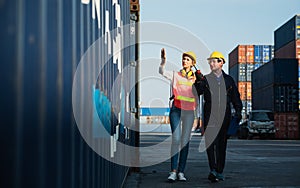 Two foreman man & woman worker working checking at Container cargo harbor to loading containers. Dock male and female staff