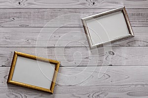 Two frames for photos on a light, vintage wooden background