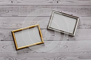 Two frames for photos on a light, vintage wooden background