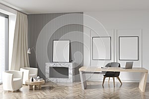 Two frames and standing artwork in modern white and grey office