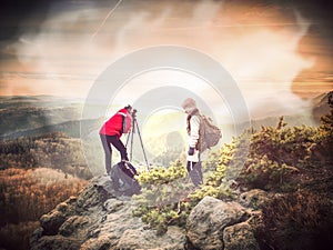 Two freelance photographers working during mountain trail