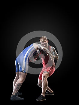 Two freestyle wrestlers figting isolated on black background