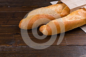 Two french bread loaves in bags