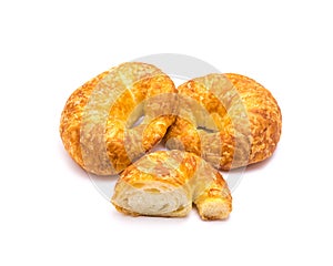 Two fresh baked French butter croissant with cutout piece isolated on white