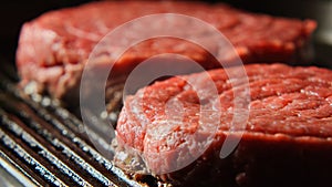 Two Fresh Beefsteaks on a grill