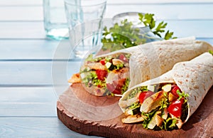 Two fresh chicken and salad tortilla wraps photo