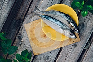 two fresh fish on a cutting Board, cooking mackerel,fish tails close up