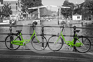 Two fresh green bikes on the streets of Amsterdam
