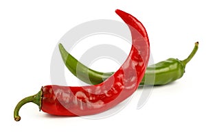 Green and red hot chili peppers close up on white