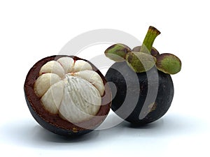 Two fresh mangosteen With one child that was cut in half to see ingrown texture antioxidants, help to slow down aging.