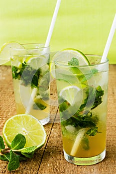 Two fresh mojitos cocktail. Mojitos with mint leaves, lime and ice