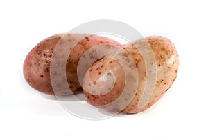 Two fresh red potatoes on a white background