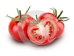 Two fresh red tomato and one cut in half with green leaves