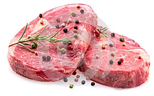 Two fresh ribeye steaks with peppercorn and rosemary isolated on white background. Closeup