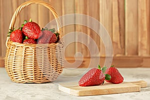 Two Fresh Ripe Red Strawberries on Cutting Board