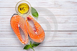 Two fresh salmon steaks with olive oil and Basil