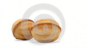 Two fresh and tasty cookies in the shape of a walnut with boiled condensed milk on a white background. A favorite