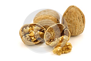 Two fresh walnuts and a cracked one